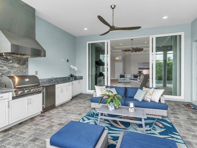 view of patio with ceiling fan, sink, outdoor lounge area, and area for grilling