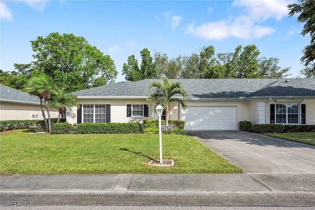 ranch-style home featuring a front lawn and a garage