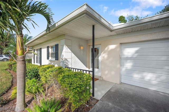 entrance to property with a garage and a porch