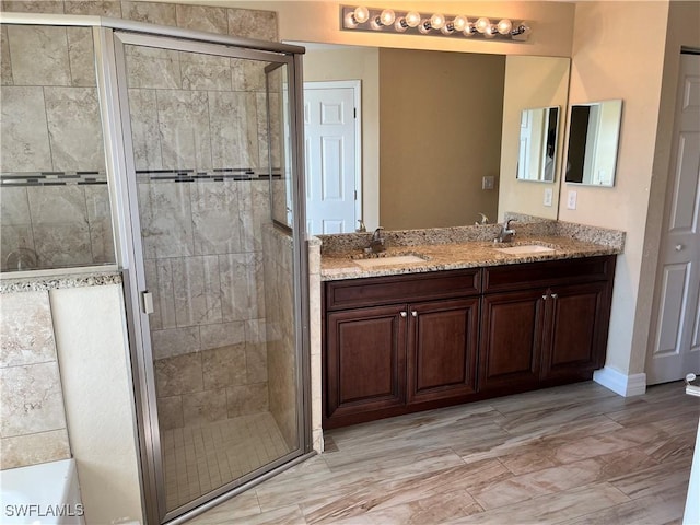 bathroom featuring vanity and a shower with shower door