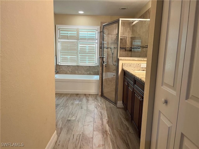 bathroom with vanity and independent shower and bath