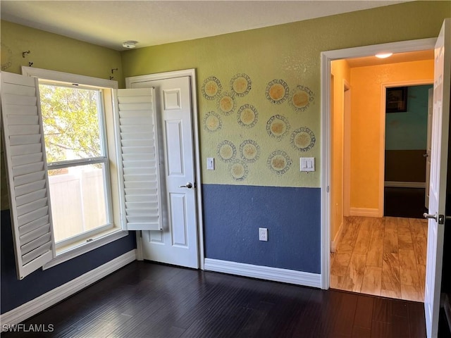 unfurnished room featuring dark wood-type flooring