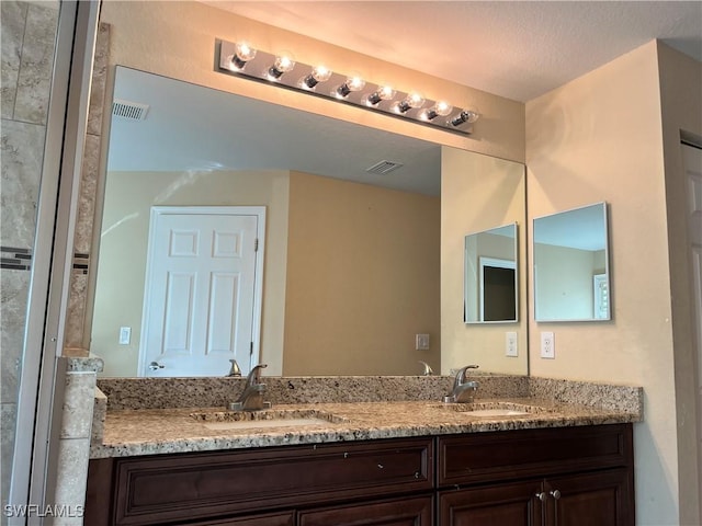 bathroom with vanity and a textured ceiling