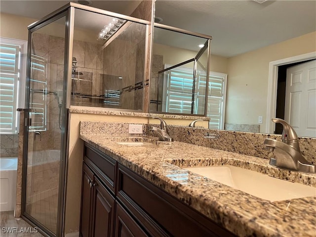 bathroom with vanity and separate shower and tub