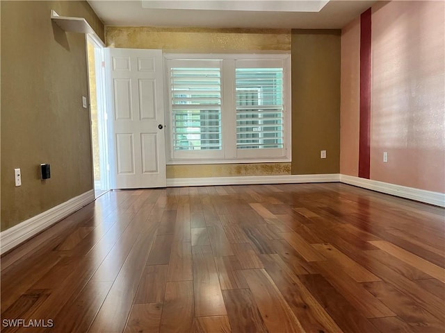 empty room with hardwood / wood-style floors