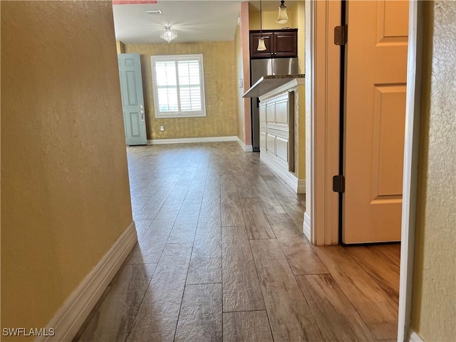 hall with wood-type flooring