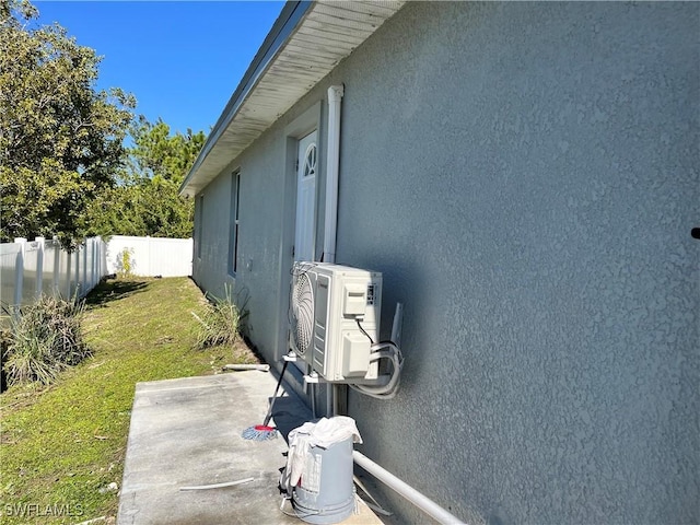 view of property exterior with a lawn and ac unit