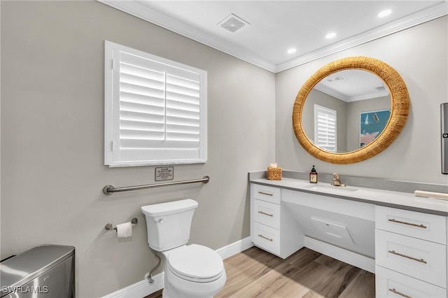 bathroom with toilet, ornamental molding, wood-type flooring, and vanity