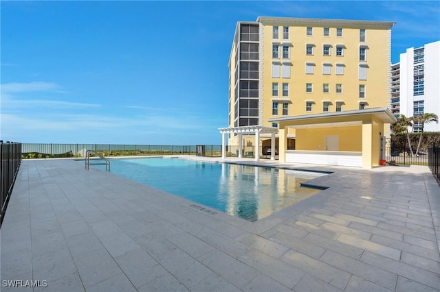 view of swimming pool featuring a patio area and a pergola