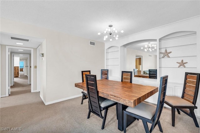 dining space featuring a textured ceiling, built in features, a chandelier, and light carpet