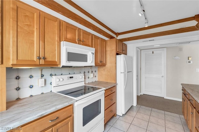 kitchen featuring light tile patterned floors, white appliances, and tasteful backsplash