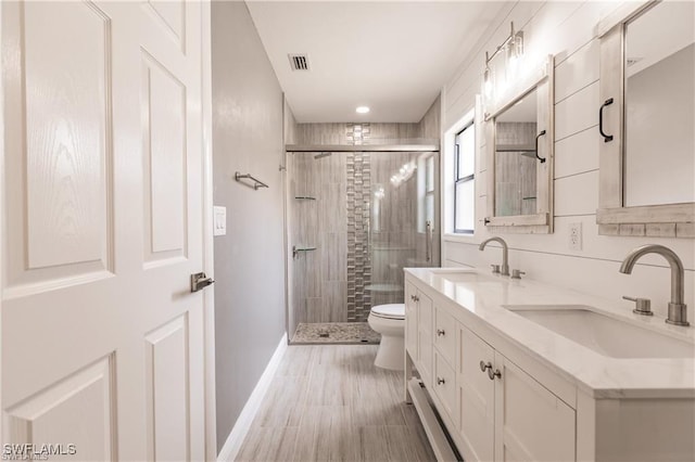 bathroom with vanity, toilet, and walk in shower