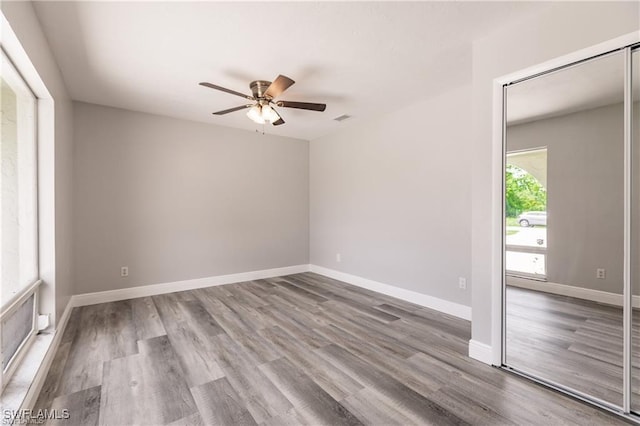 empty room with hardwood / wood-style flooring and ceiling fan