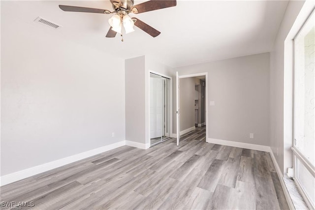 unfurnished bedroom featuring a closet, ceiling fan, and light hardwood / wood-style flooring