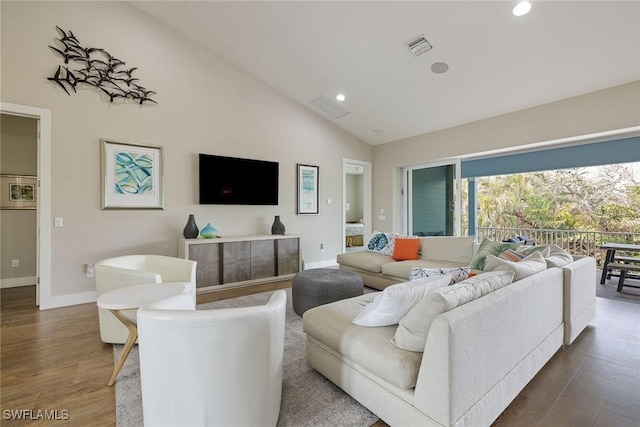 living room featuring wood-type flooring and high vaulted ceiling