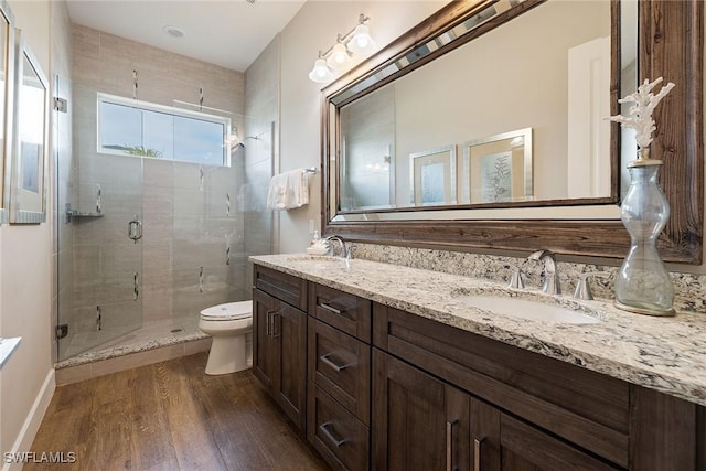 bathroom with vanity, hardwood / wood-style flooring, toilet, and walk in shower