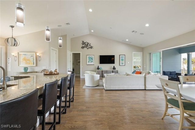 living room with hardwood / wood-style floors and lofted ceiling