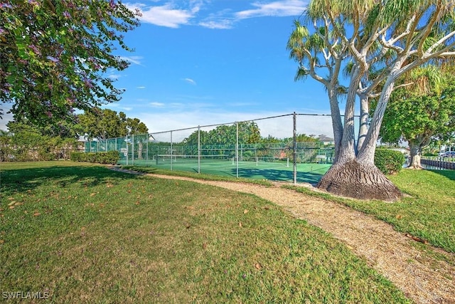 view of sport court featuring a lawn