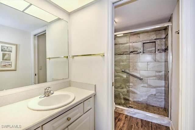 bathroom featuring vanity, hardwood / wood-style flooring, and a shower with door