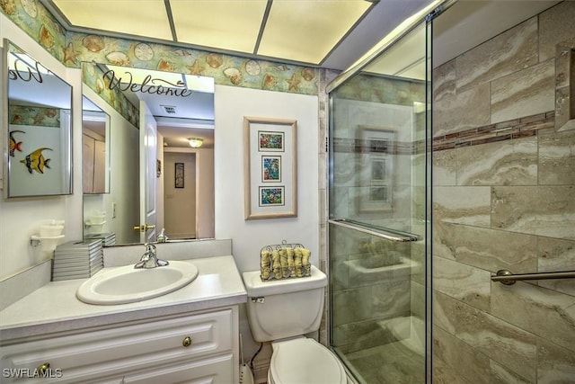 bathroom with vanity, an enclosed shower, and toilet