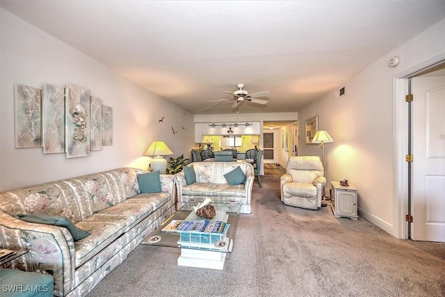 carpeted living room featuring ceiling fan