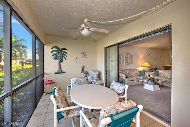 sunroom / solarium featuring ceiling fan