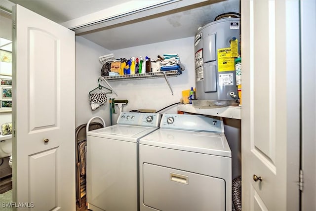 clothes washing area with washer and dryer and electric water heater