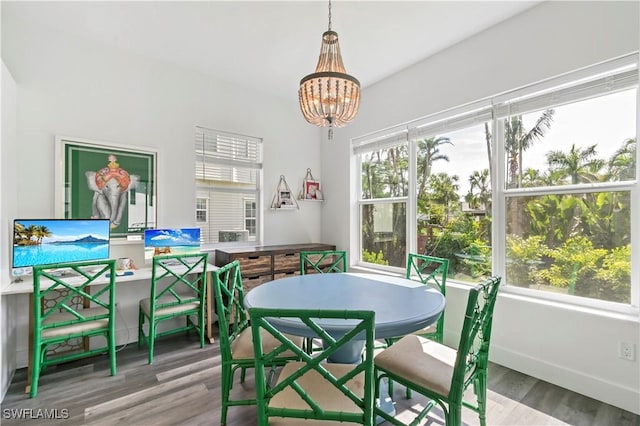 dining area featuring hardwood / wood-style floors and a notable chandelier