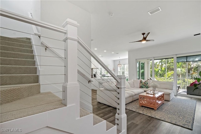 stairway featuring hardwood / wood-style floors and ceiling fan