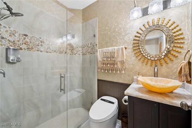 bathroom with a stall shower, vanity, and toilet