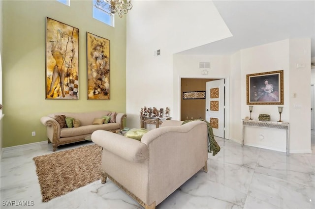 living room featuring marble finish floor, baseboards, a high ceiling, and visible vents