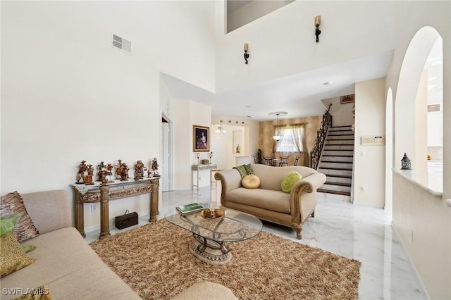 10125 N Golden Elm Dr, Estero, FL 33928 - living area with stairs, marble finish floor, arched walkways, baseboards, and visible vents