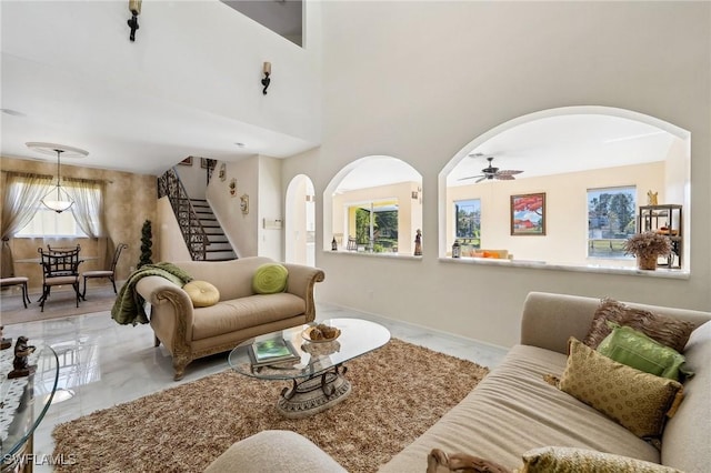 10125 N Golden Elm Dr, Estero, FL 33928 - living room with arched walkways, marble finish floor, stairs, and ceiling fan
