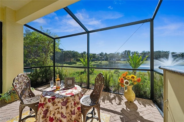 sunroom featuring a water view and plenty of natural light