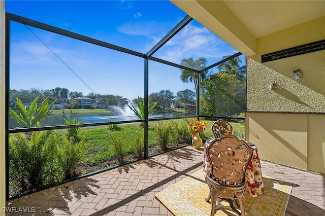 unfurnished sunroom featuring a water view