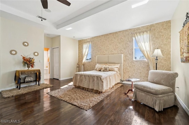 bedroom with a ceiling fan, baseboards, visible vents, and wood finished floors