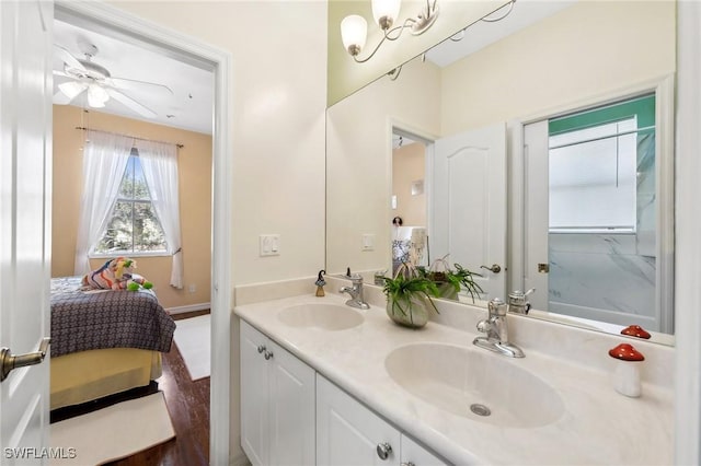 ensuite bathroom featuring double vanity, a notable chandelier, a sink, and ensuite bathroom