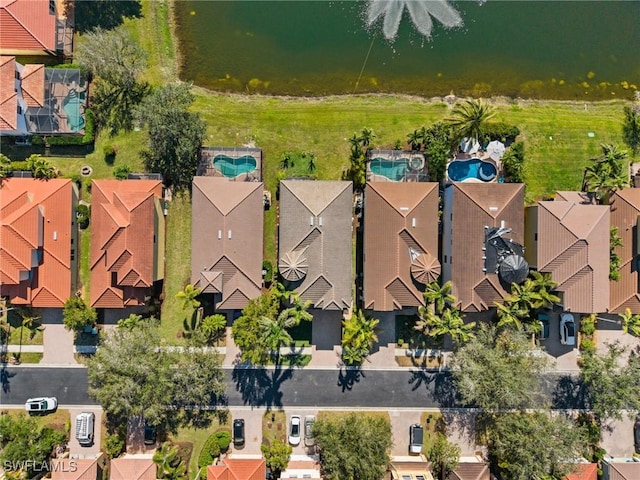 drone / aerial view featuring a water view and a residential view