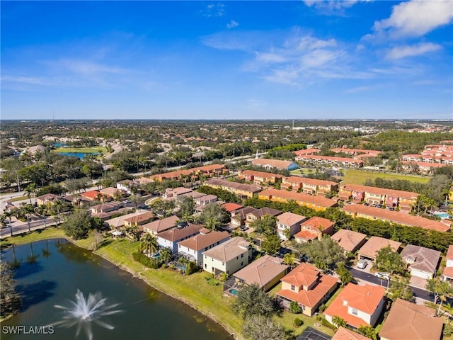 drone / aerial view with a water view and a residential view