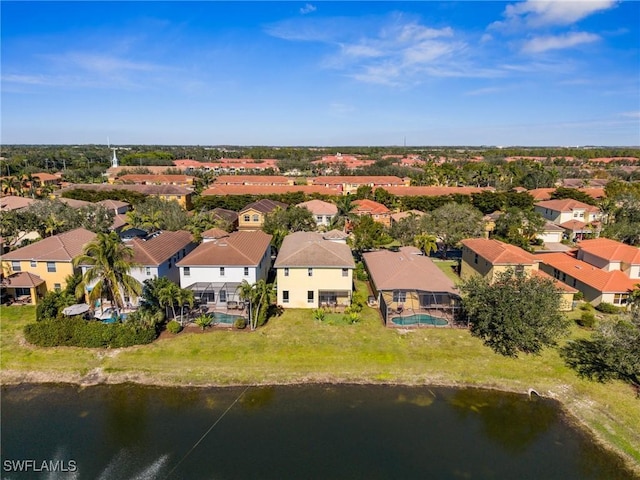 drone / aerial view featuring a water view and a residential view