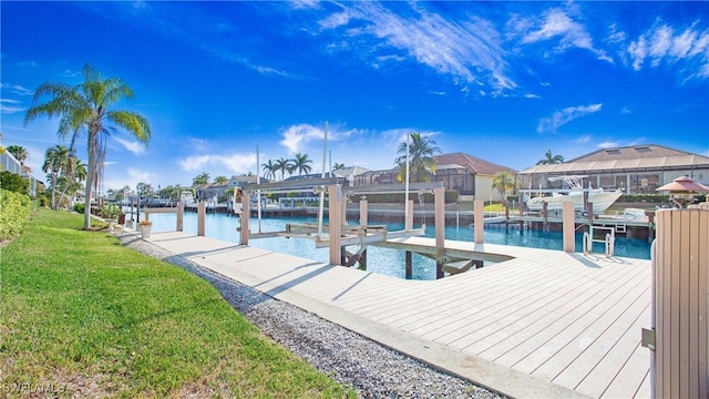 dock area featuring a lawn and a water view