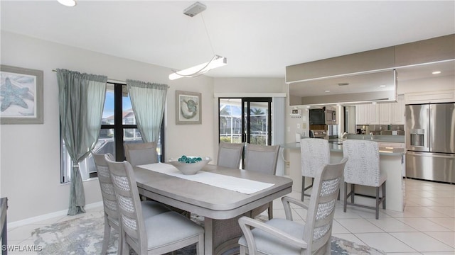 dining room featuring french doors and light tile patterned floors