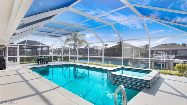 view of pool with a lanai, a patio area, and an in ground hot tub