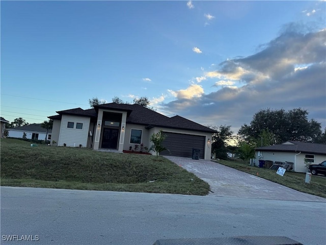 view of front of home featuring a front yard and a garage