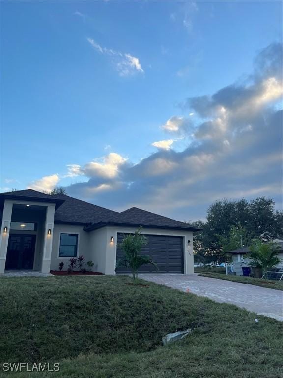 view of front facade with a garage and a front lawn