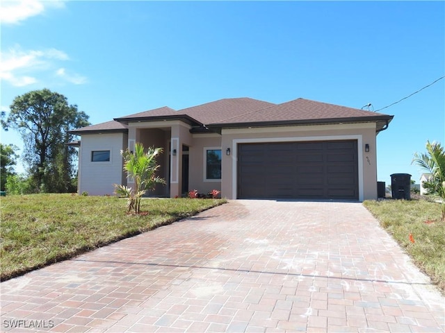 view of front facade with a garage and a front lawn