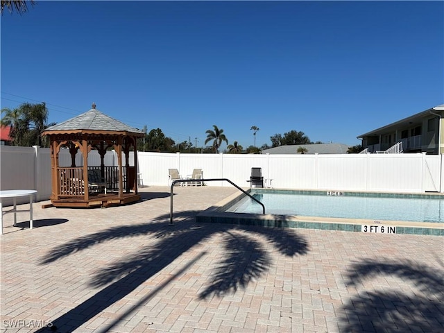 view of swimming pool with a gazebo and a patio area