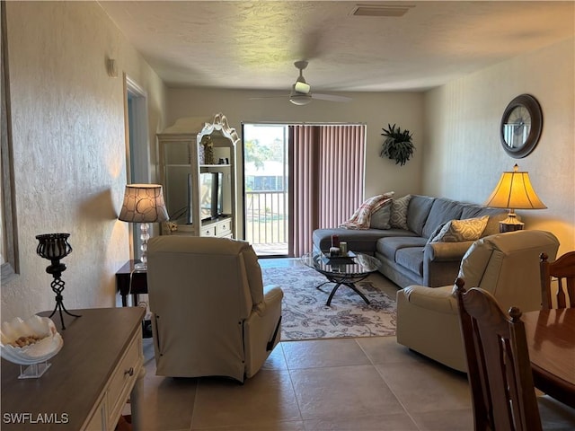 living room featuring ceiling fan and light tile patterned floors