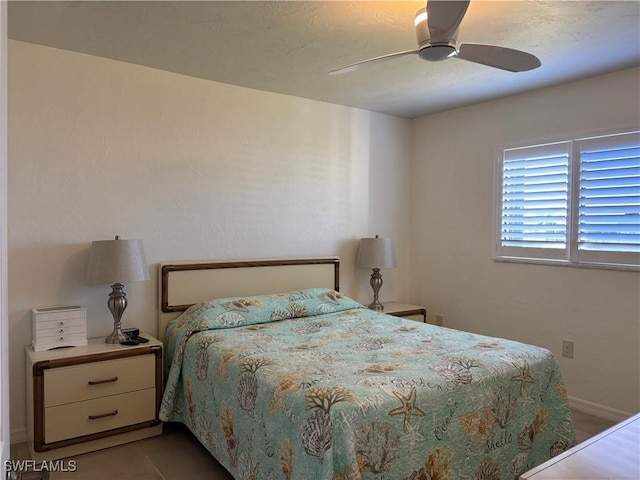 tiled bedroom featuring ceiling fan