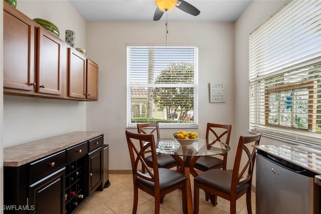 tiled dining space featuring ceiling fan